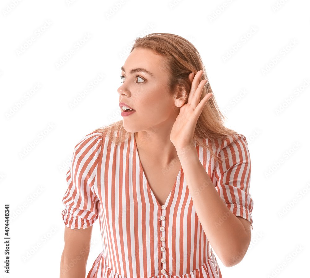 Curious young woman trying to hear something on white background Curious young woman trying to hear something on white background