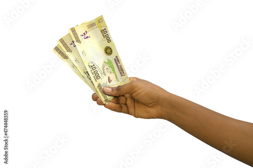 Fair hand holding 3D rendered 10000 Malagasy ariary notes isolated on white background