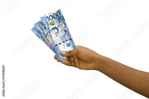 Fair hand holding 3D rendered 1000 Philippines peso notes isolated on white background