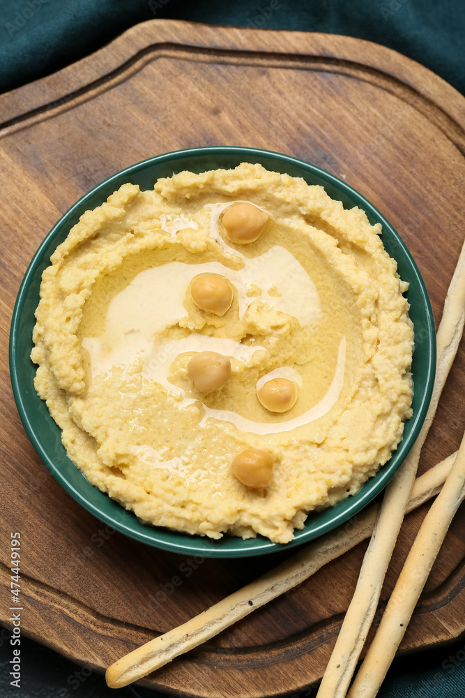 Bowl with delicious hummus on table, closeup Bowl with delicious hummus on table, closeup