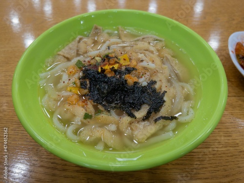 Udon with tofu in a light green bowl