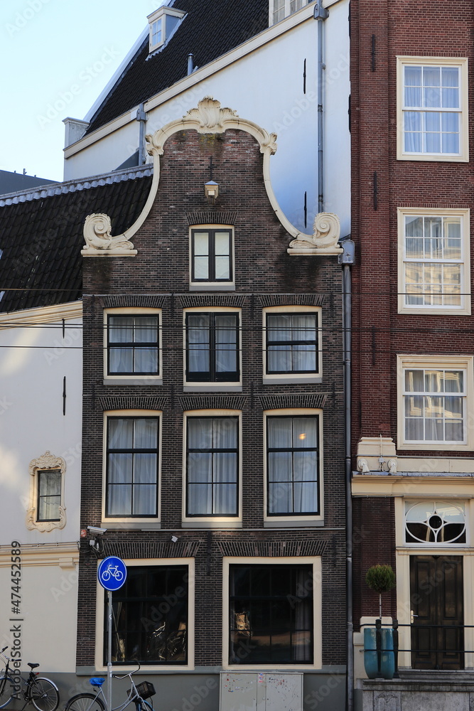 Historic Brown Brick House Facade with Bell Gable in Amsterdam, Holland Historic Brown Brick House Facade with Bell Gable in Amsterdam, Holland