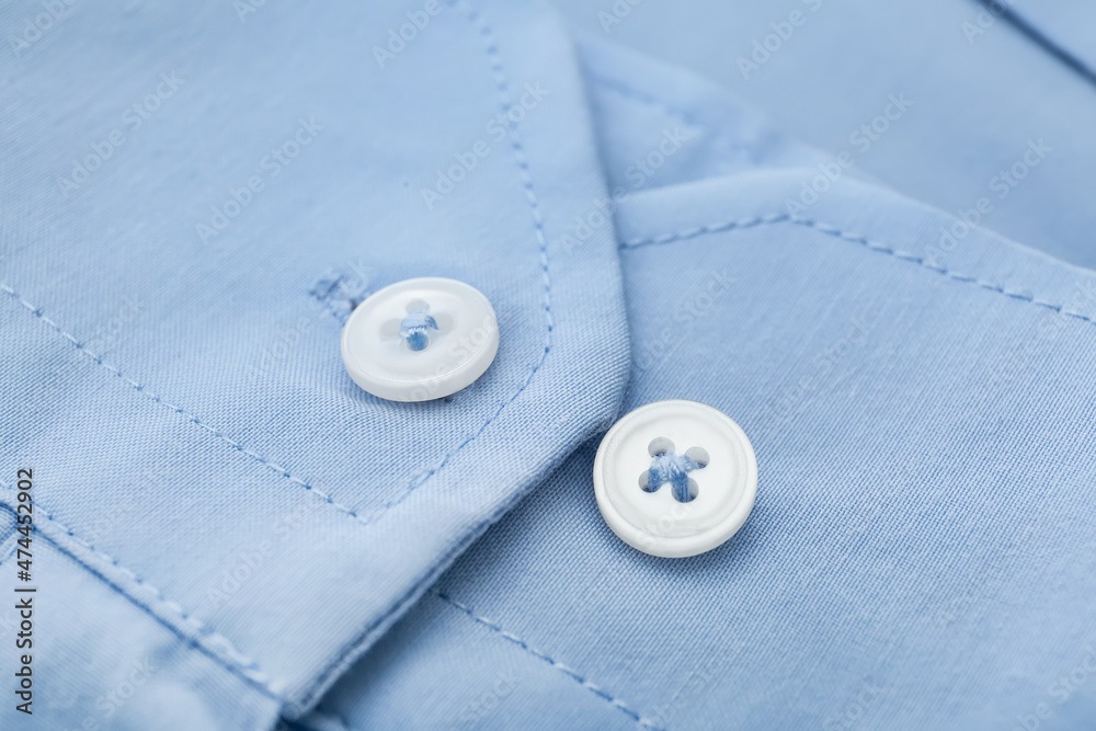 Closeup view of buttons on blue shirt Closeup view of buttons on blue shirt