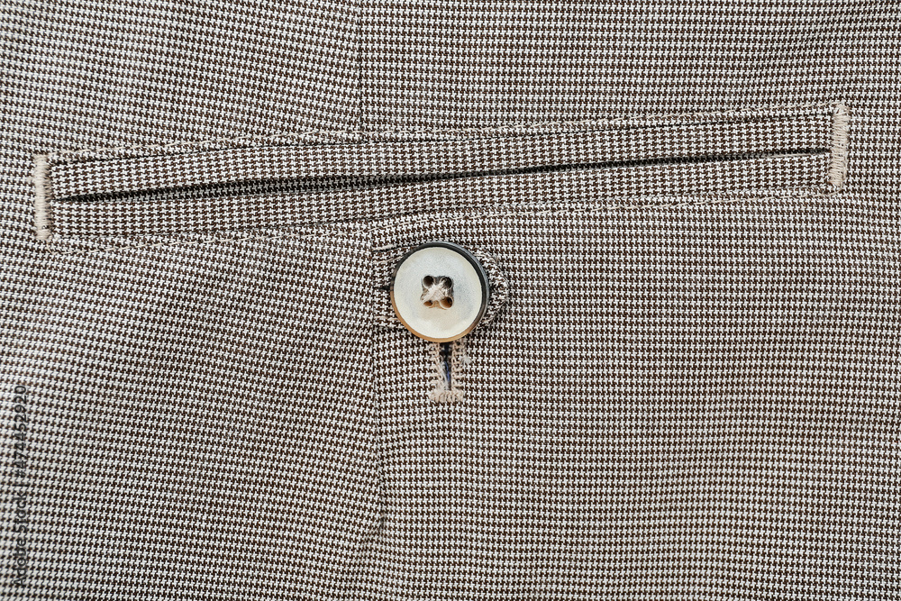 Button on grey pants, closeup Button on grey pants, closeup