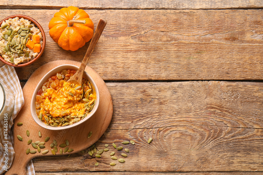 Bowls of tasty oatmeal with pumpkin on wooden background