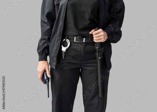 Female security guard on grey background