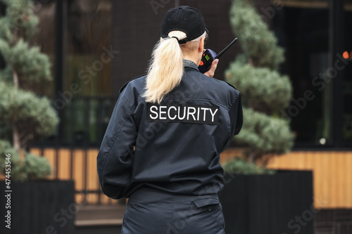 Female security guard outdoors, back view photo