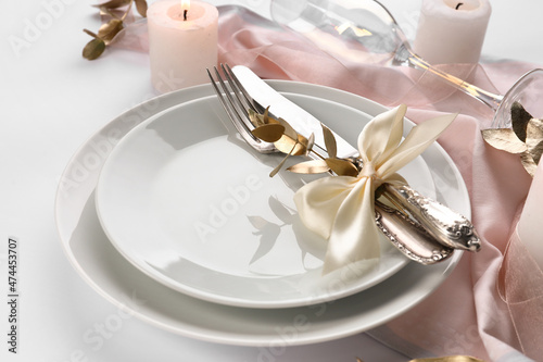 Beautiful table setting for wedding celebration on white background, closeup
