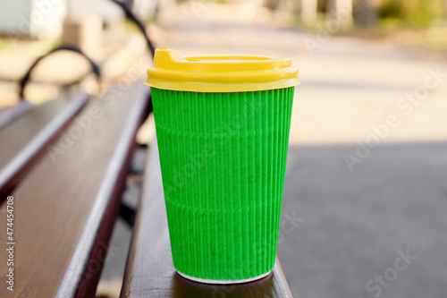 Takeaway cup of tasty latte on bench in park © Pixel-Shot