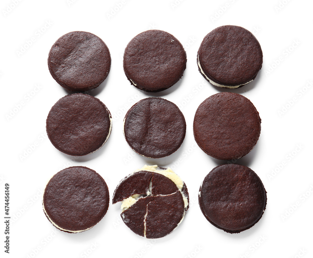 Tasty chocolate cookies with cream on white background