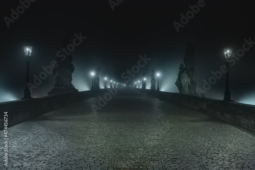 Fotografiet Street lamps and light from them on the old stone Charles Bridge in the night fo