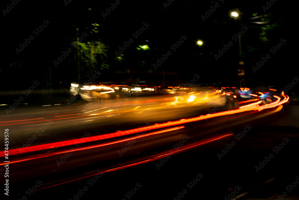 Car Light trails on a city street in a dark black night. Photo is taken with long exposure. Car Light trails on a city street in a dark black night. Photo is taken with long exposure.