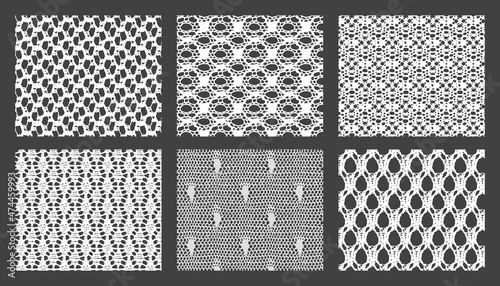 Bundle of lace mesh fabric. Black and white textures.