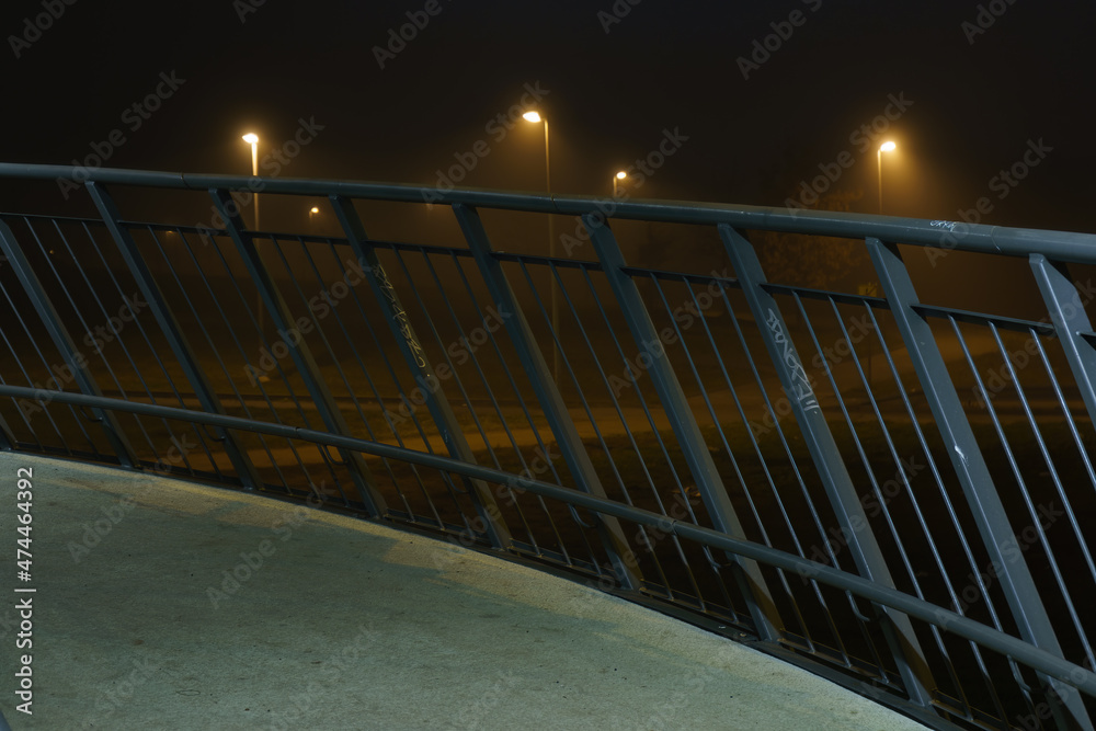 Fototapeta premium street lights under a concrete bridge in the fog in the city of Prague at night 2021