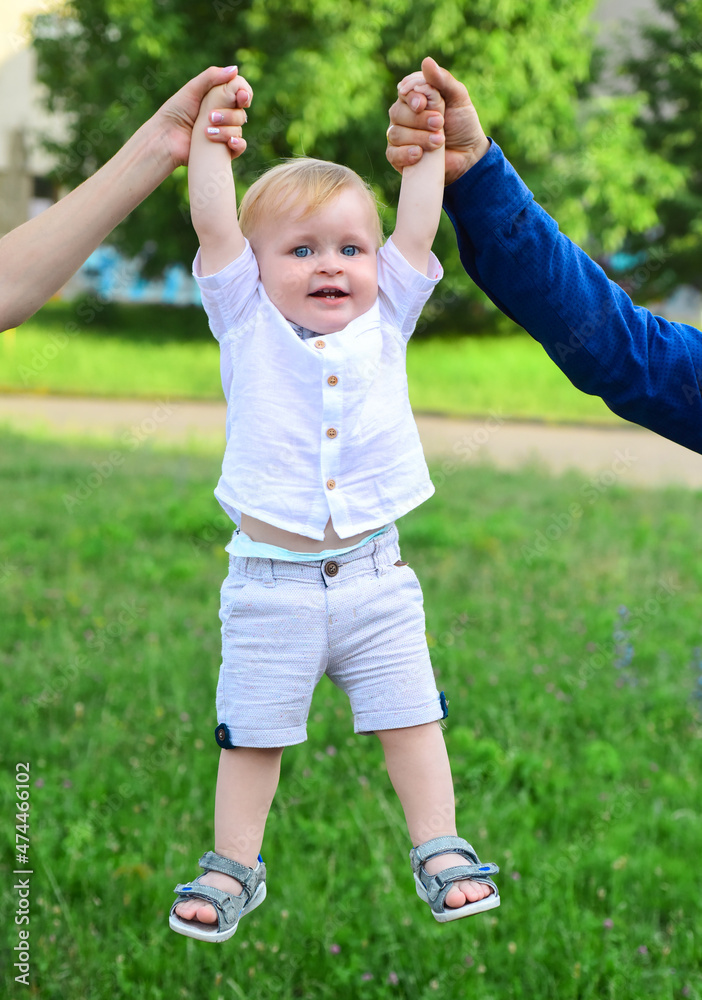 Cute little caucasian boy having fun in garden. Child on green grass lawn during walk in yard. Happy childhood and baby healthcare. Cute little caucasian boy having fun in garden. Child on green grass lawn during walk in yard. Happy childhood and baby healthcare.