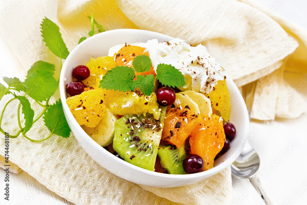 Salad fruit with cranberries and cream in bowl on wooden board Salad fruit with cranberries and cream in bowl on wooden board