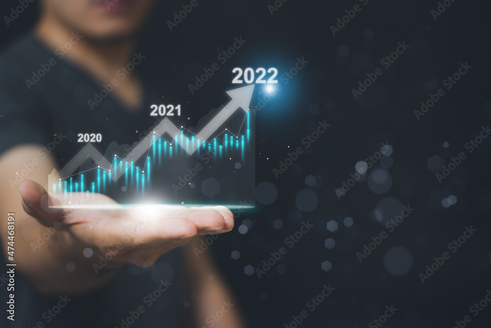 Businessman or trader displays a glowing virtual technical investment chart for stock market analysis, Financial Concepts and Banking Planning Businessman or trader displays a glowing virtual technical investment chart for stock market analysis, Financial Concepts and Banking Planning