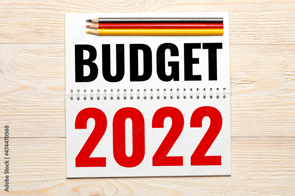budget 2022 in notepad with black red yellow pencils on wooden table budget 2022 in notepad with black red yellow pencils on wooden table