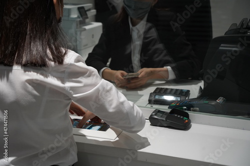 Almaty, Kazakhstan - 11.16.2021 : Bank tellers recalculate banknotes of different denominations