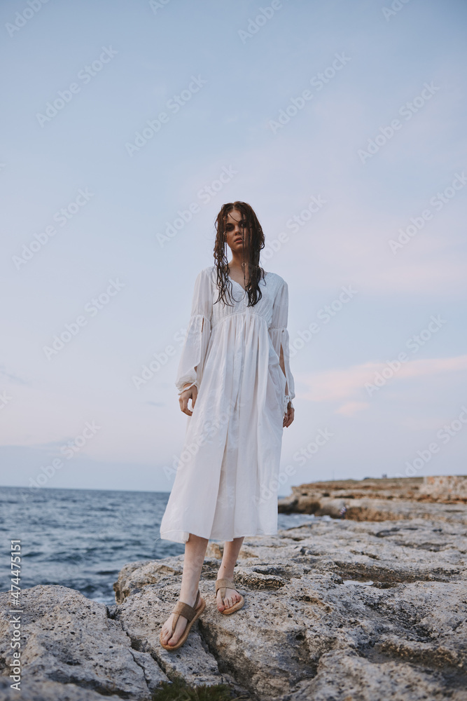 woman traveler in white dress at the sea beach relax