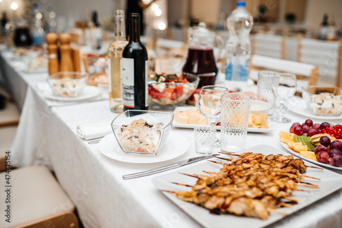 beautifully set table at a wedding banquet with delicious food and alcohol