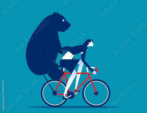 Riding a bicycle carrying a bear behind. Bear market concept