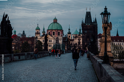 paving of lamps and statues on the half-empty Charles Bridge on the Vltava river in the center of Prague during the day 2021 during a pandemic