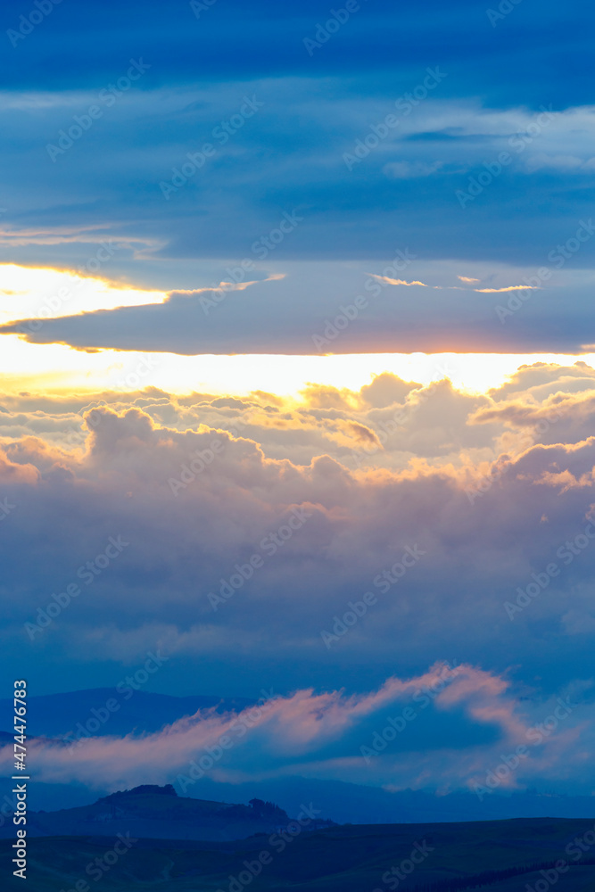Sunset with colorful clouds in the sky in a mountainous landscape