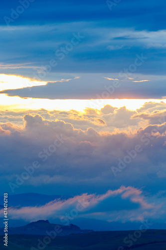 Sunset with colorful clouds in the sky in a mountainous landscape