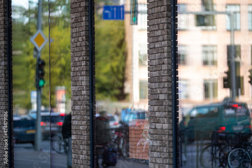 urban background with large shop windows reflecting the street with people and traffic