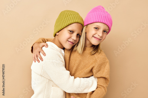 little children in sweaters beige background friendship hug childhood
