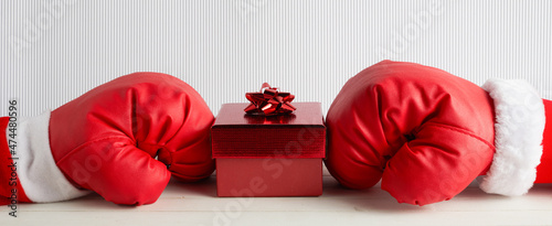 Boxing day shopping creative idea. Boxing glove with gift box. photo