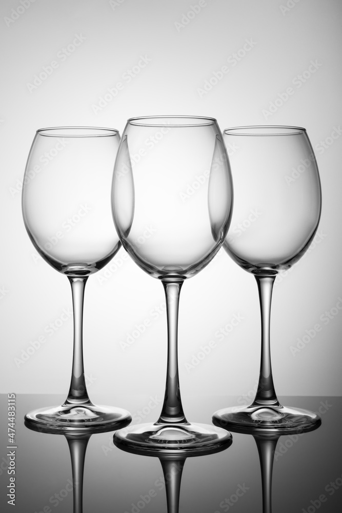 Three of empty glasses on a black table with a reflection Three of empty glasses on a black table with a reflection