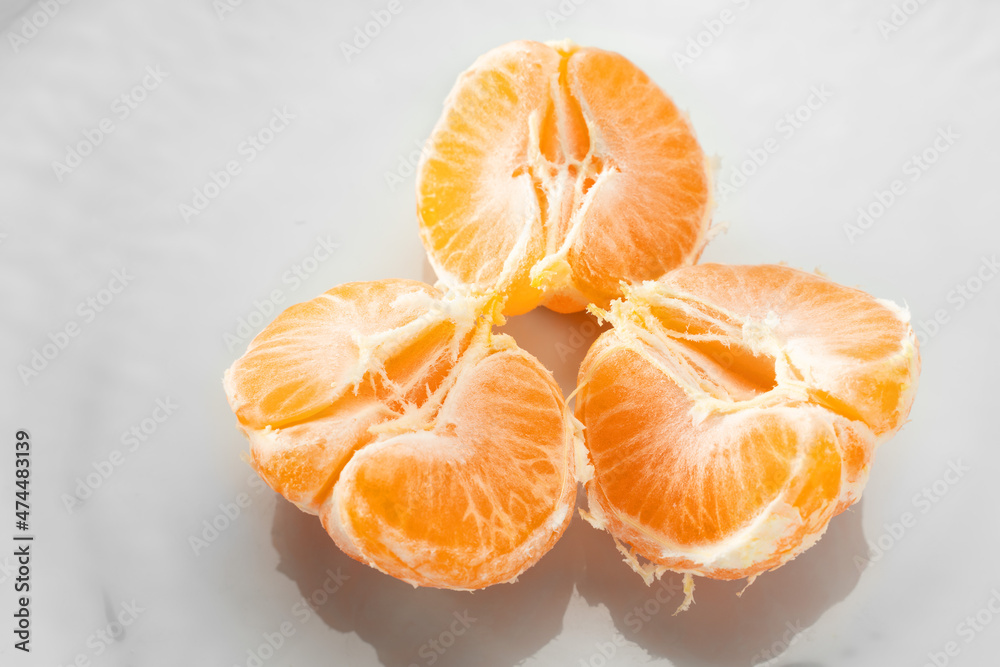 Ripe tangerines on a white plate. Top view Ripe tangerines on a white plate. Top view