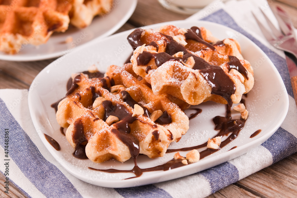 Waffles with chocolate cream and hazelnuts. Waffles with chocolate cream and hazelnuts.