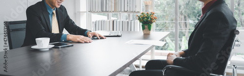 Businessman in formal suite interviewing candidate at office photo