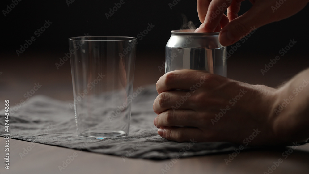 man hand open can with drink on wood table