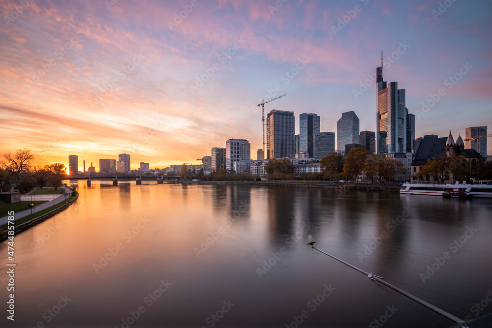 Frankfurt am Main in Germany. City view in a street with skyline and skyscrapers. These are reflected in a puddle