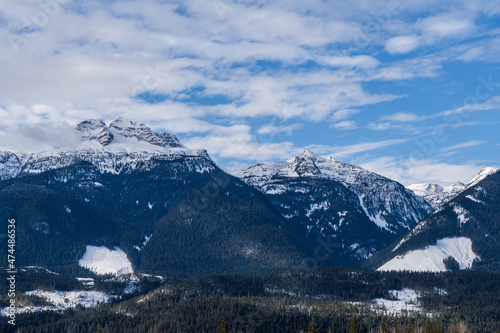 panorama of high mountains covered by snow cloudy blue sky british columbia canada © olegmayorov