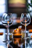 empty wine glasses on a large served table in warm lighting vertical photo

