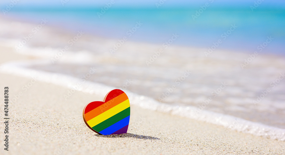LGBT heart on the sandy beach against the background of the sea. Concept of the best resort for lgbt couples LGBT heart on the sandy beach against the background of the sea. Concept of the best resort for lgbt couples