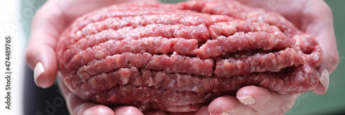Female hands holding minced beef meat closeup