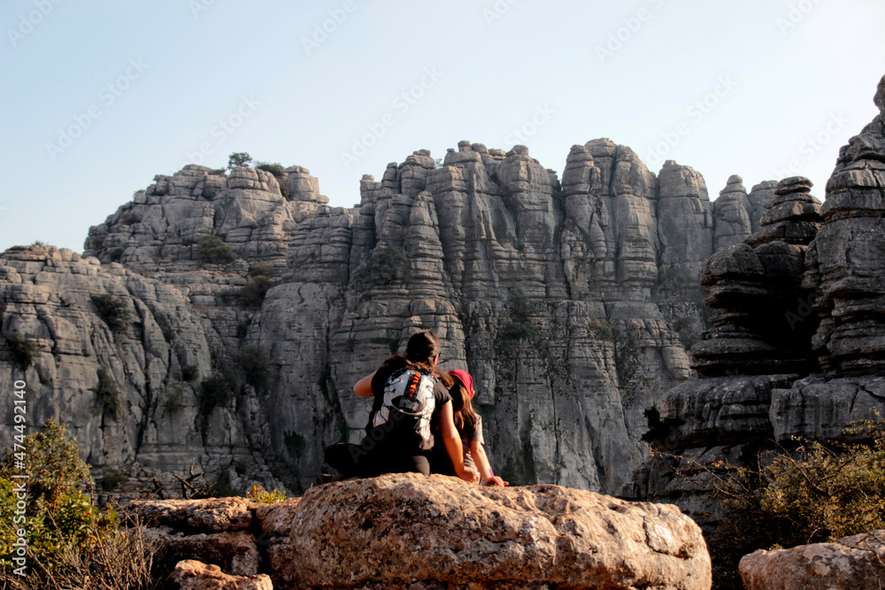Obraz premium Mother and daughter relaxing, observing the Torcal rock formations, near Antequera.