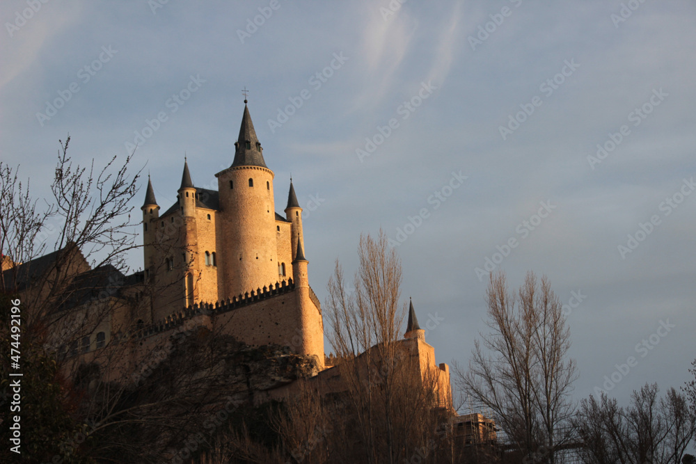 View of the Alcazar of Segovia at sunset. This fortress castle inspired the castles of Disney and the movie Hotel Transylvania.