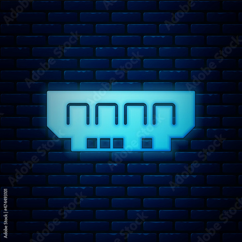 Glowing neon RAM, random access memory icon isolated on brick wall background. Vector