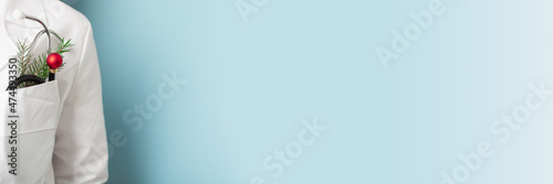 Christmas banner for medicine with doctor on blue background. Copy space