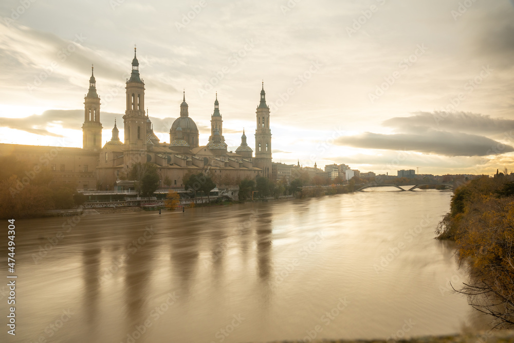 Long exposure at dusk of the Basilica of Our Lady of the Pillar from the Ebro river in the city of Zaragoza, Aragon. Spain