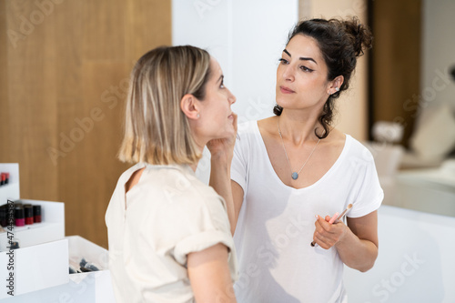 Arab makeup artist making up a woman in a beauty center.