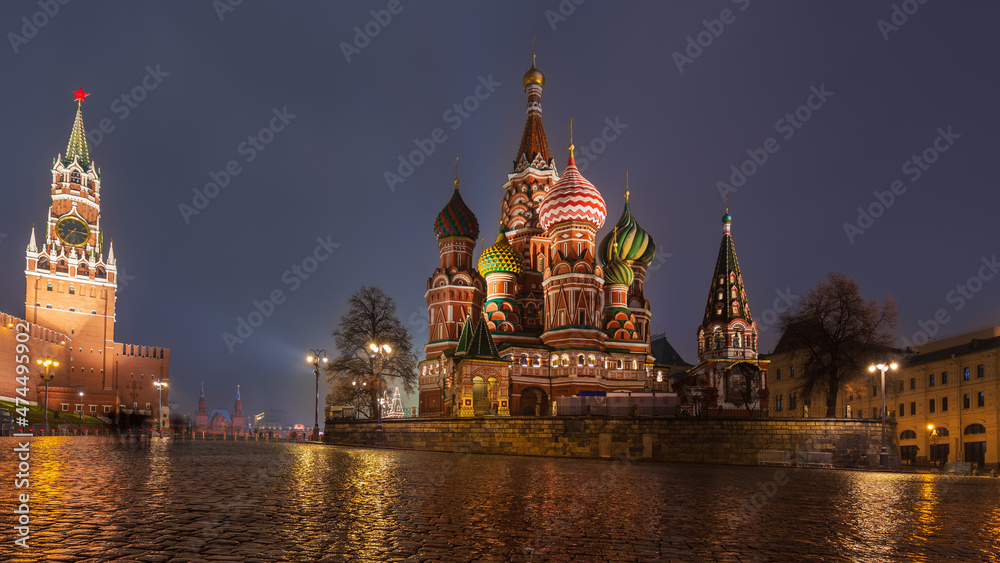 Moscow historic center with illuminated St. Basil's Cathedral and Kremlin Tower on rainy night