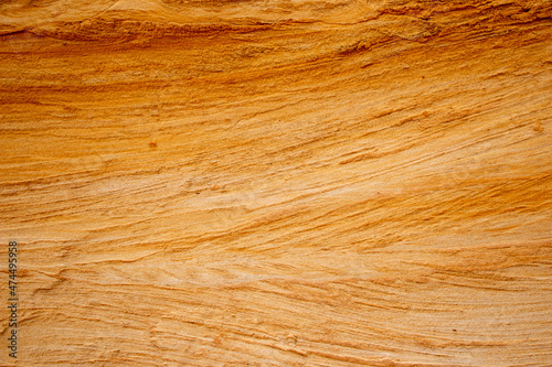 Textural sand, with  relief surface, multi-colored layers and different in size of granules, in outdoor sand career, after mining ore and sand for construction.